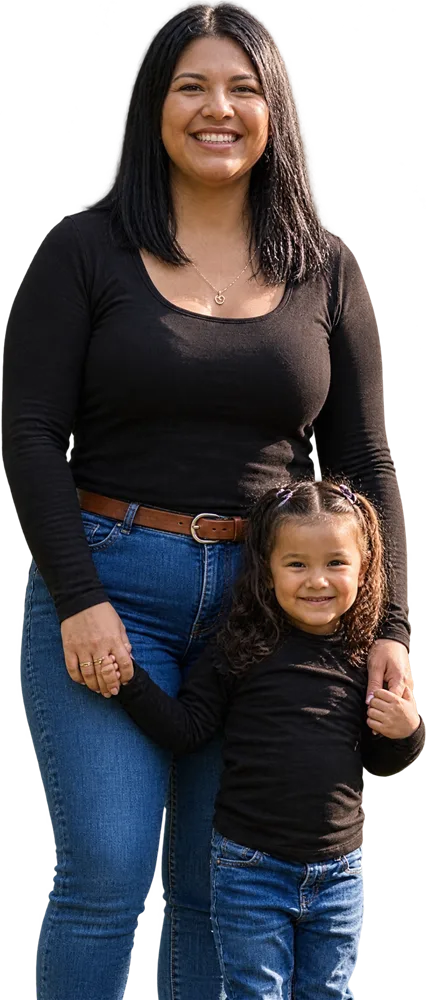A smiling mother holding hands with her young daughter